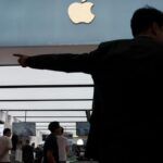 Apple logo over a digital cloud background representing iCloud storage services.