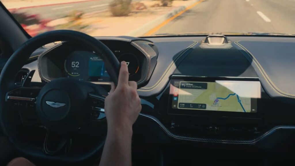 CarPlay video playback feature on iPhone streaming to a car's infotainment screen via AirPlay in iOS 26 update.