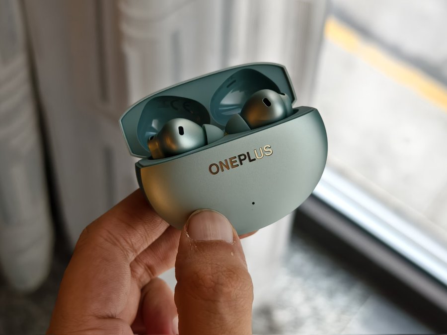 OnePlus Buds 4 wireless earbuds with dual-driver setup, advanced ANC, and long battery life, available in Zen Green and Storm Grey colors."