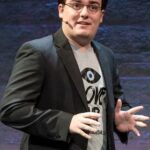 Palmer Luckey presenting at a technology summit, discussing future innovations
