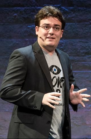 Palmer Luckey presenting at a technology summit, discussing future innovations